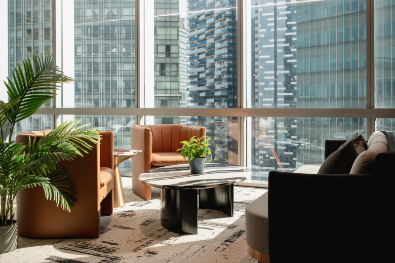 High rise office lounge against city skyscrapers 