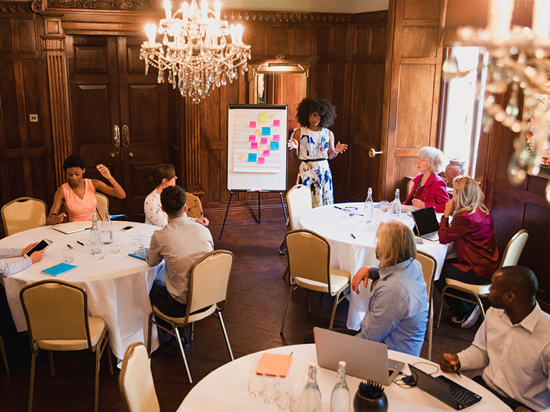 group of experts conducting a meeting to come up with strategies on how to sell a hotel in Tampa, FL